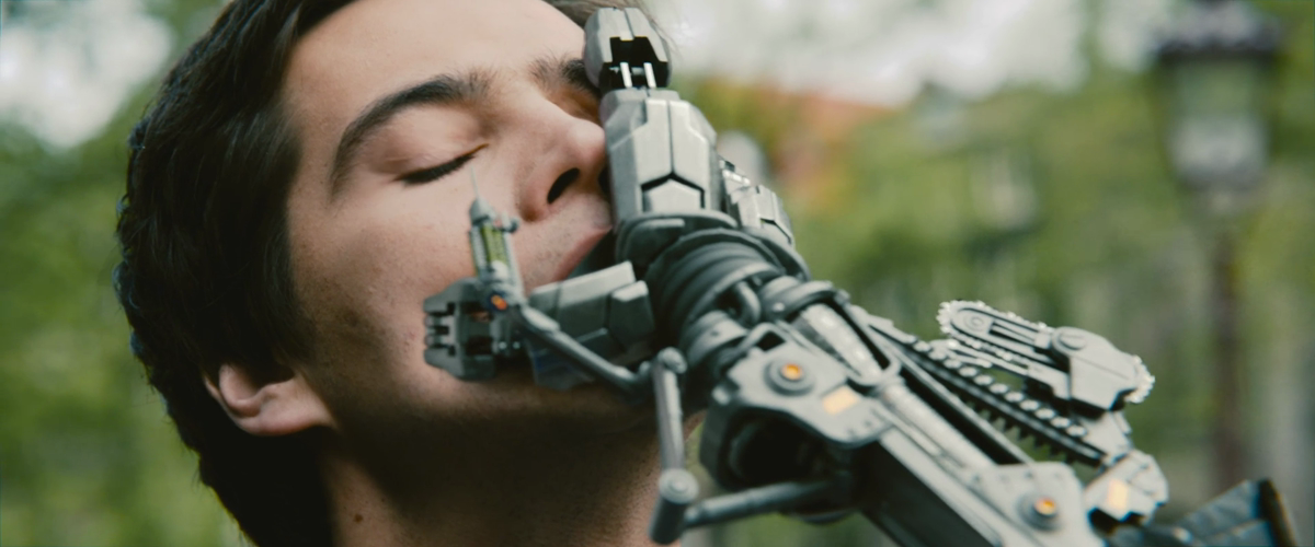 A mechanical hand reaches toward a face